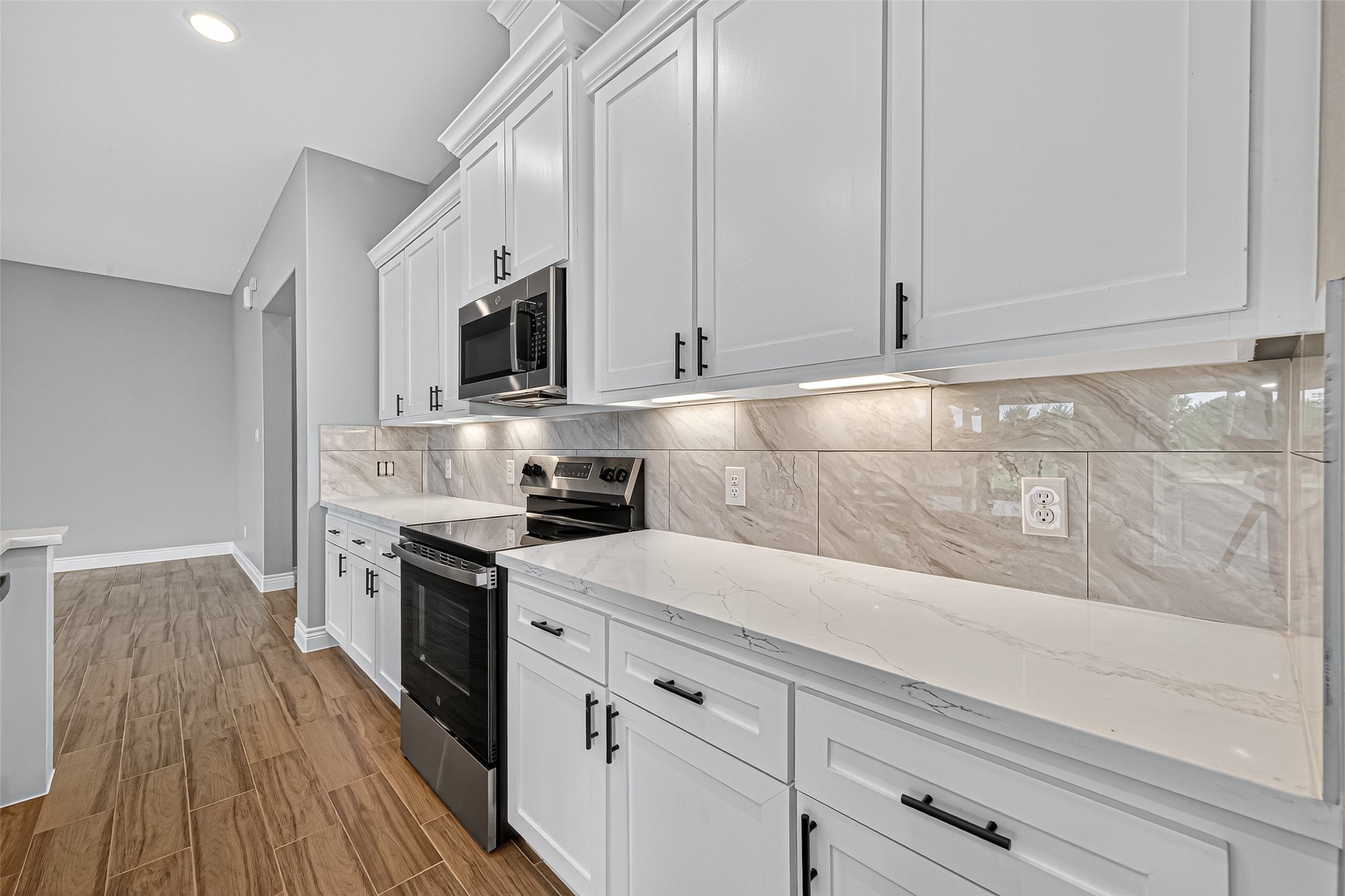 501 Oleander Street Hempstead, TX 77445 - Photo 25 of 48 a kitchen with granite countertop cabinets stainless steel appliances and wooden floor