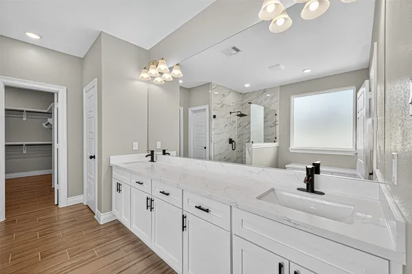 a bathroom with a double vanity sink and a mirror