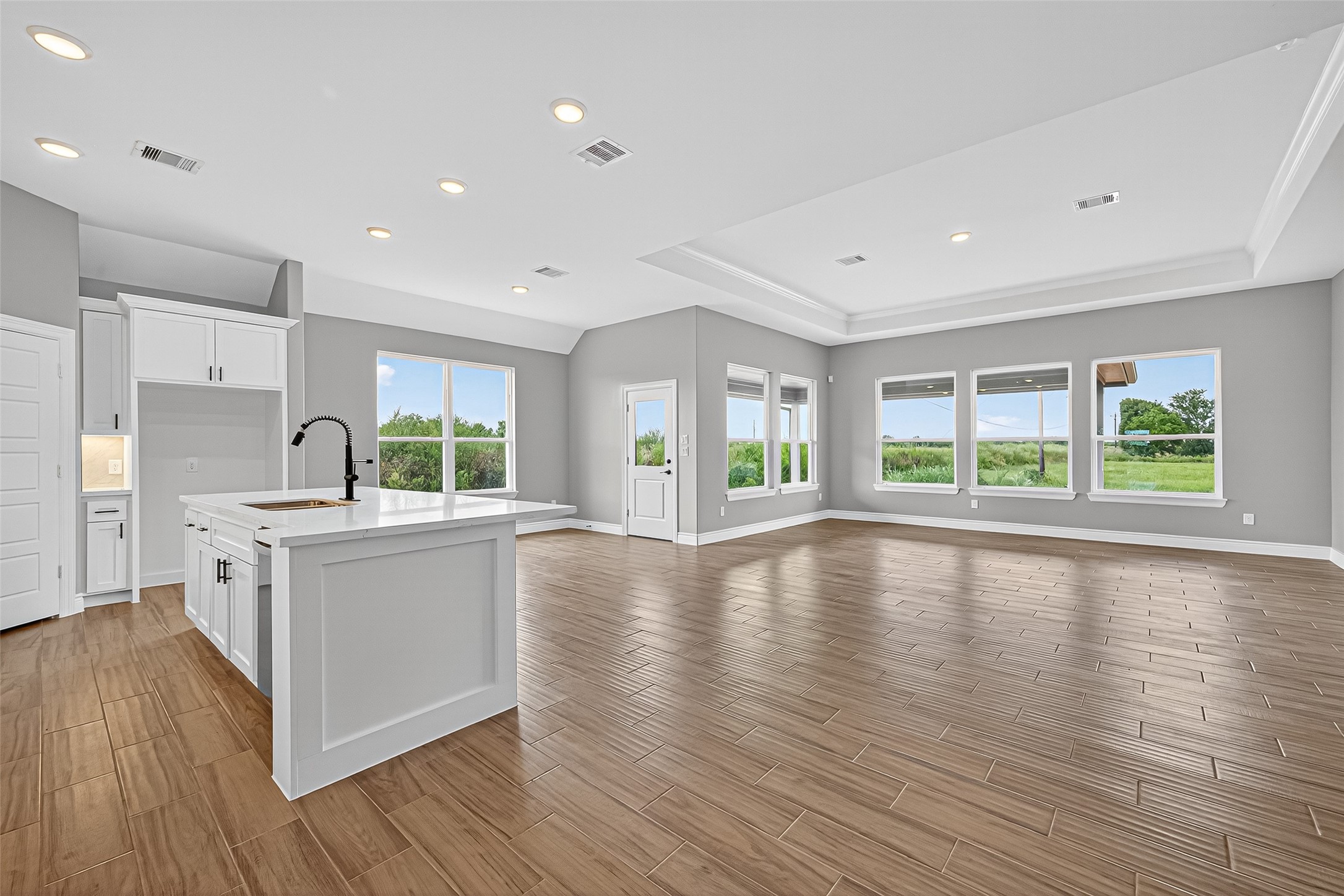501 Oleander Street Hempstead, TX 77445 - Photo 8 of 48 a large white kitchen with wooden floors and stainless steel appliances