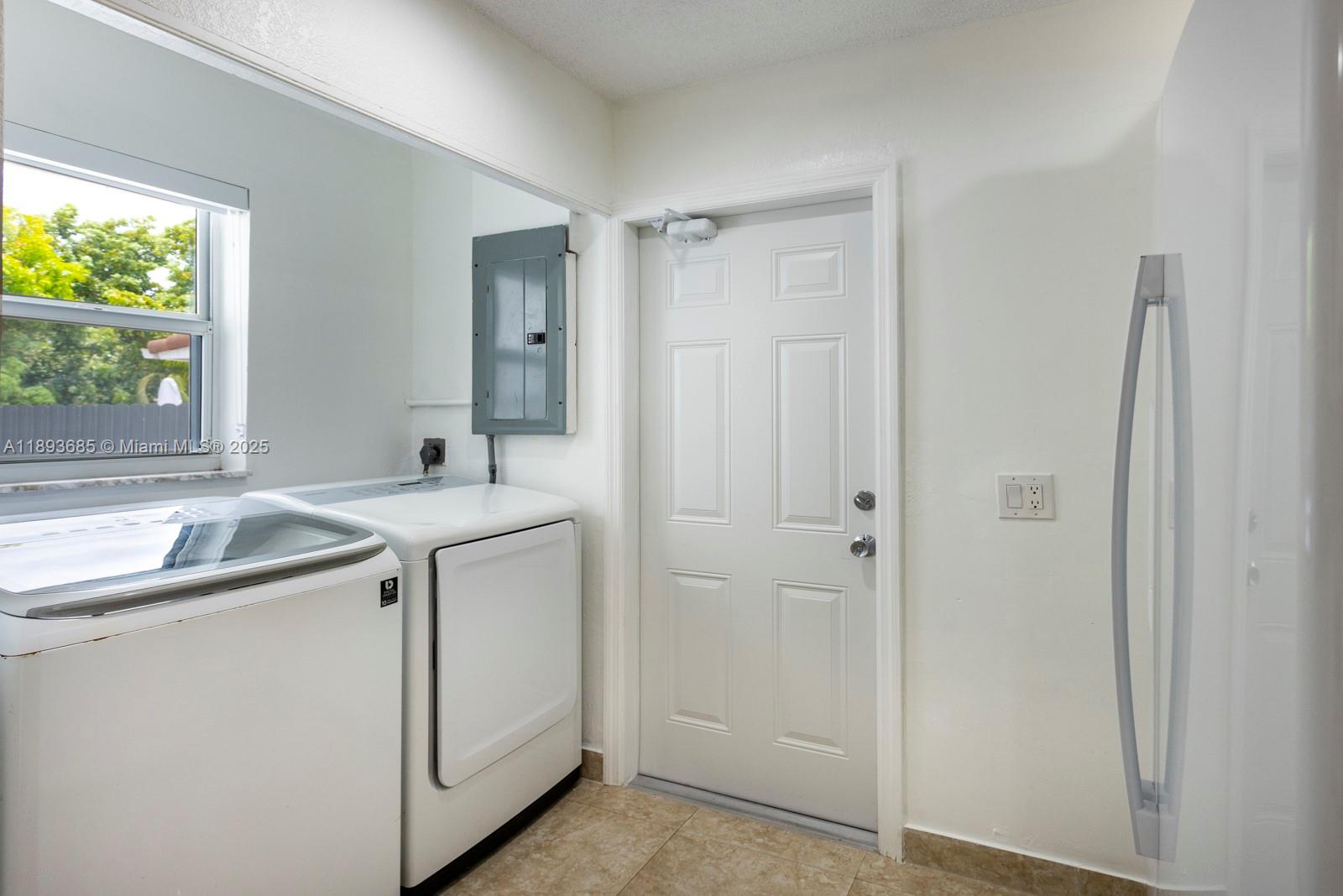 10770 Southwest 26th Street Miami, FL 33165 - Photo 11 of 35 a utility room with cabinets washer and dryer