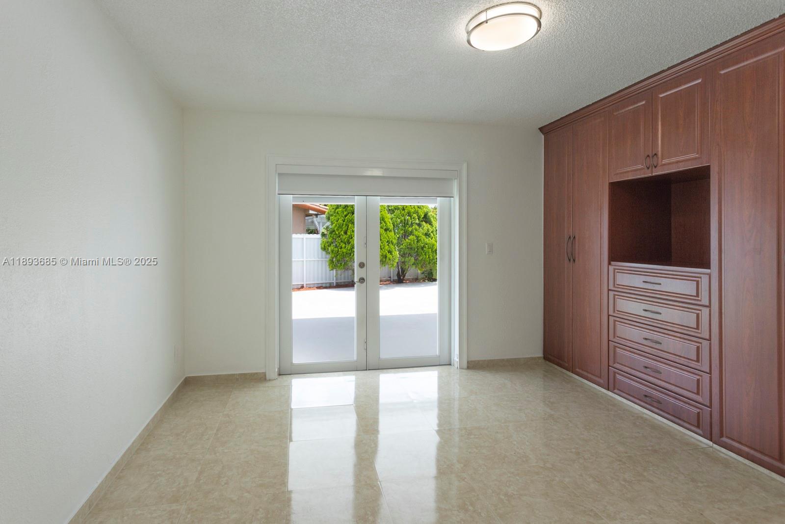 10770 Southwest 26th Street Miami, FL 33165 - Photo 12 of 35 an empty room with windows and closet