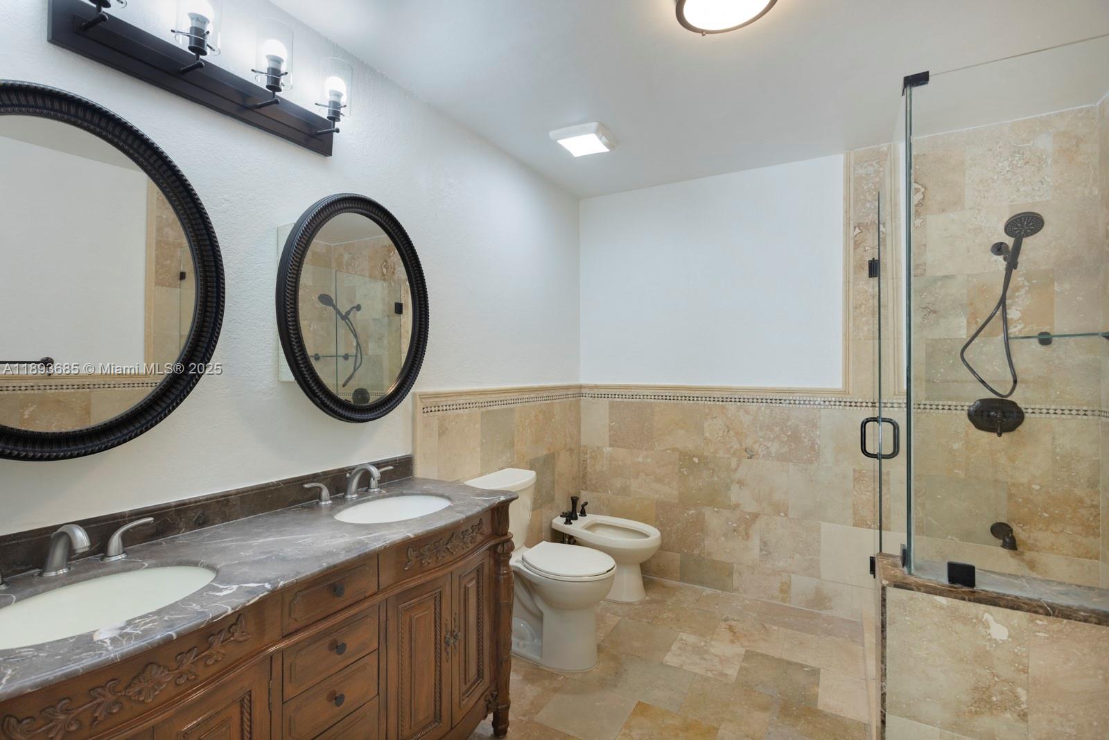 10770 Southwest 26th Street Miami, FL 33165 - Photo 14 of 35 a bathroom with a granite countertop toilet a sink and a mirror