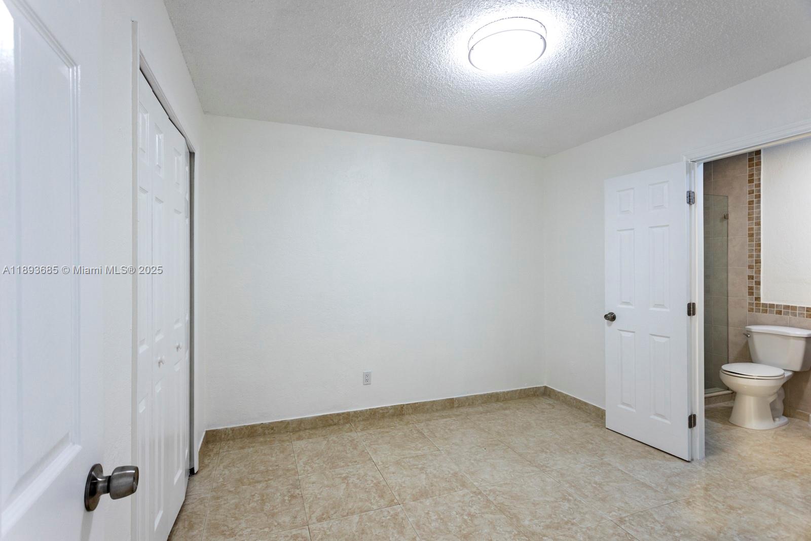 10770 Southwest 26th Street Miami, FL 33165 - Photo 15 of 35 a view of a closet area with wooden floor