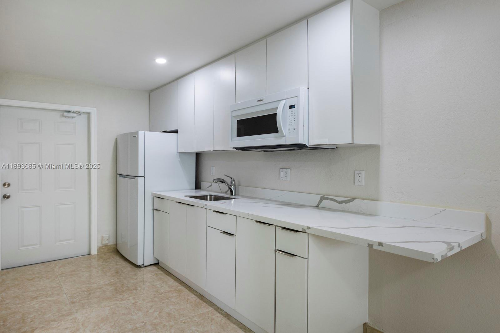 10770 Southwest 26th Street Miami, FL 33165 - Photo 20 of 35 a kitchen with stainless steel appliances granite countertop a refrigerator sink and microwave