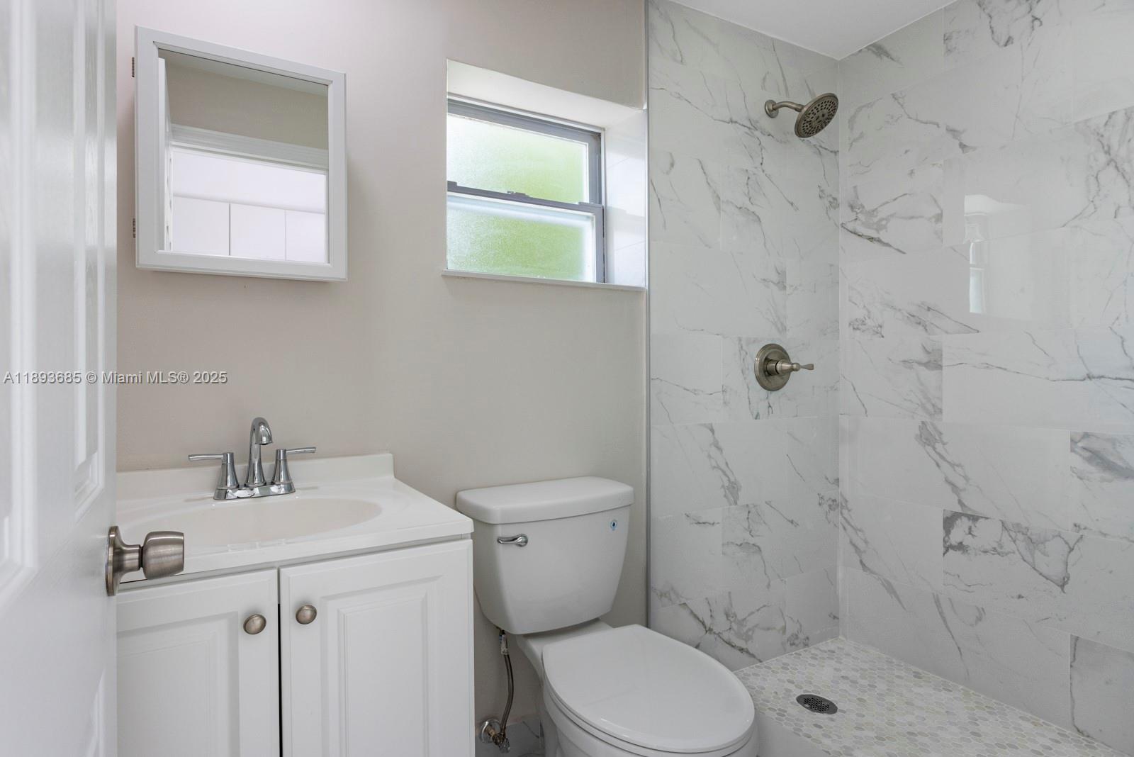 10770 Southwest 26th Street Miami, FL 33165 - Photo 22 of 35 a bathroom with a sink toilet and shower