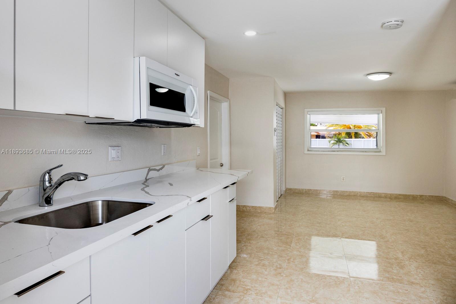 10770 Southwest 26th Street Miami, FL 33165 - Photo 23 of 35 a kitchen with stainless steel appliances granite countertop a sink and a microwave