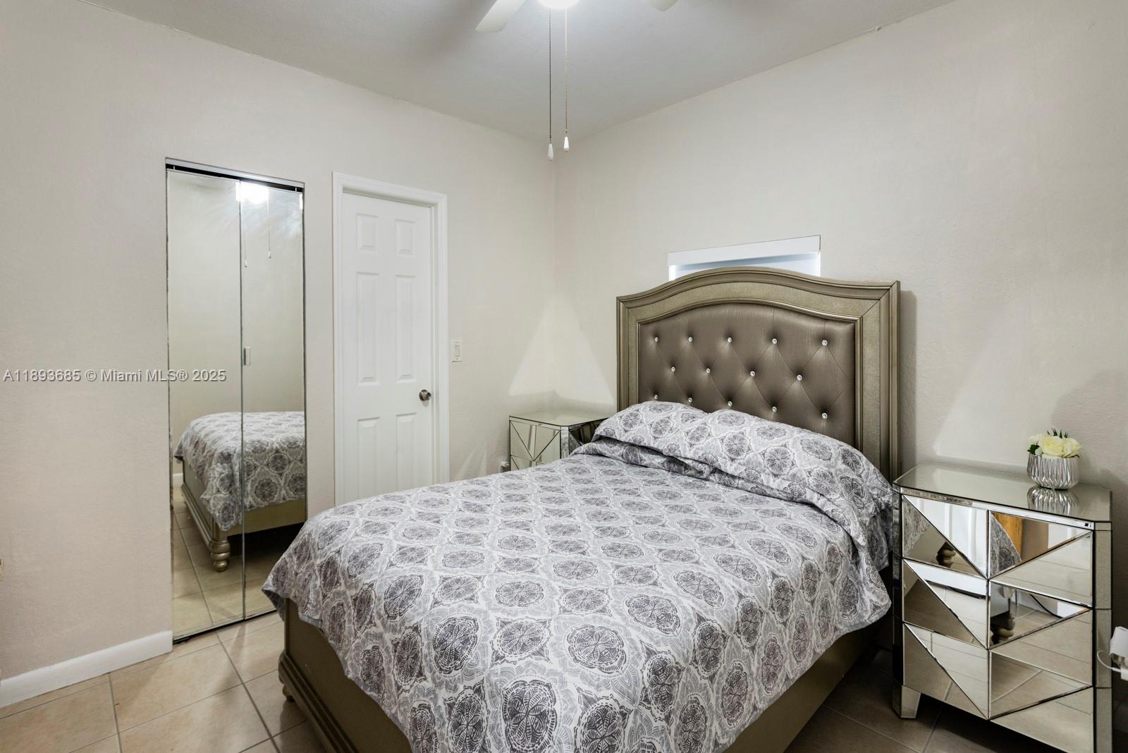 10770 Southwest 26th Street Miami, FL 33165 - Photo 26 of 35 a bedroom with a bed and a chandelier