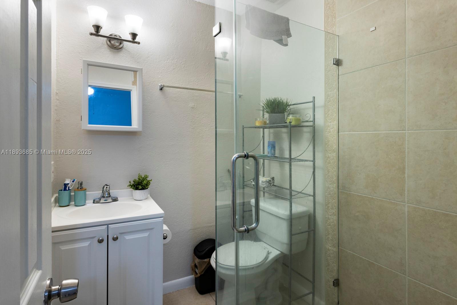 10770 Southwest 26th Street Miami, FL 33165 - Photo 27 of 35 a bathroom with a sink toilet and shower