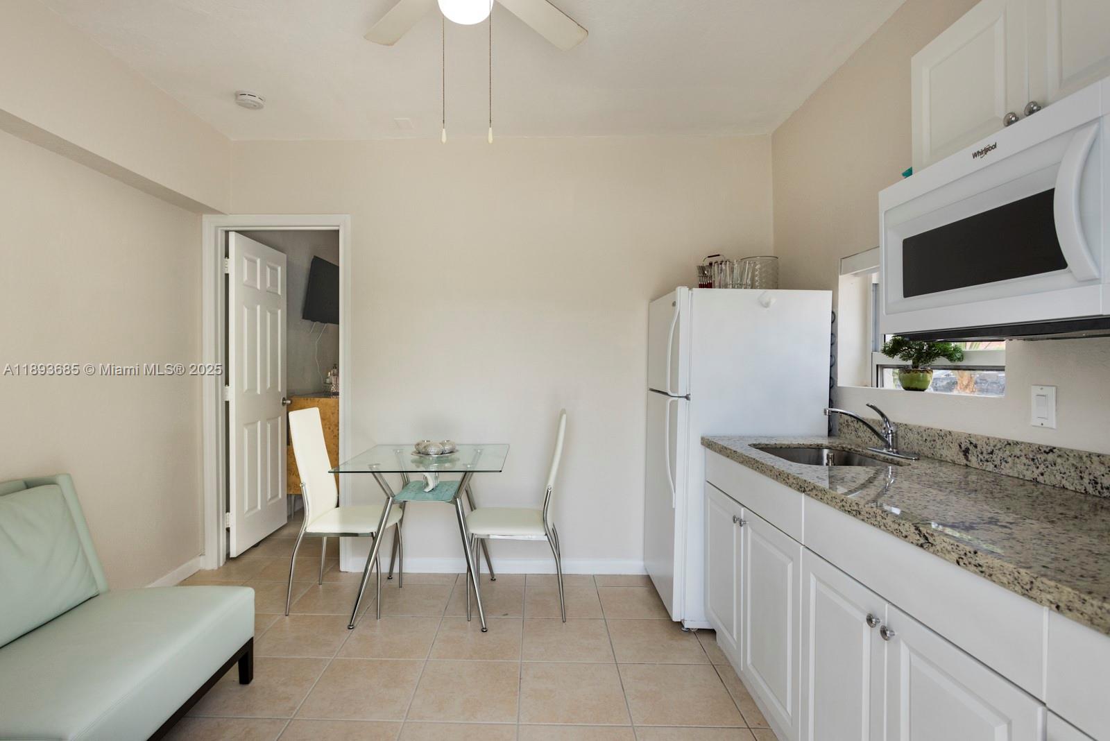 10770 Southwest 26th Street Miami, FL 33165 - Photo 28 of 35 a dining room with furniture and a flat screen tv