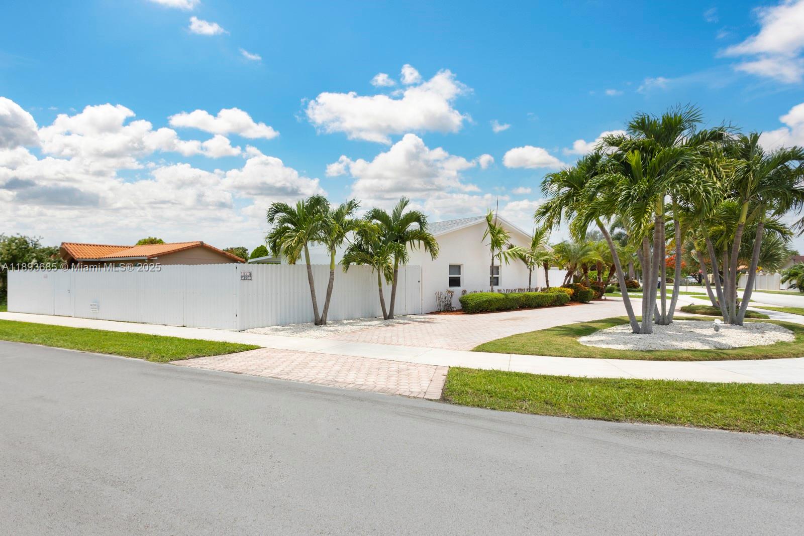 10770 Southwest 26th Street Miami, FL 33165 - Photo 3 of 35 a swimming pool with an outdoor space and seating area
