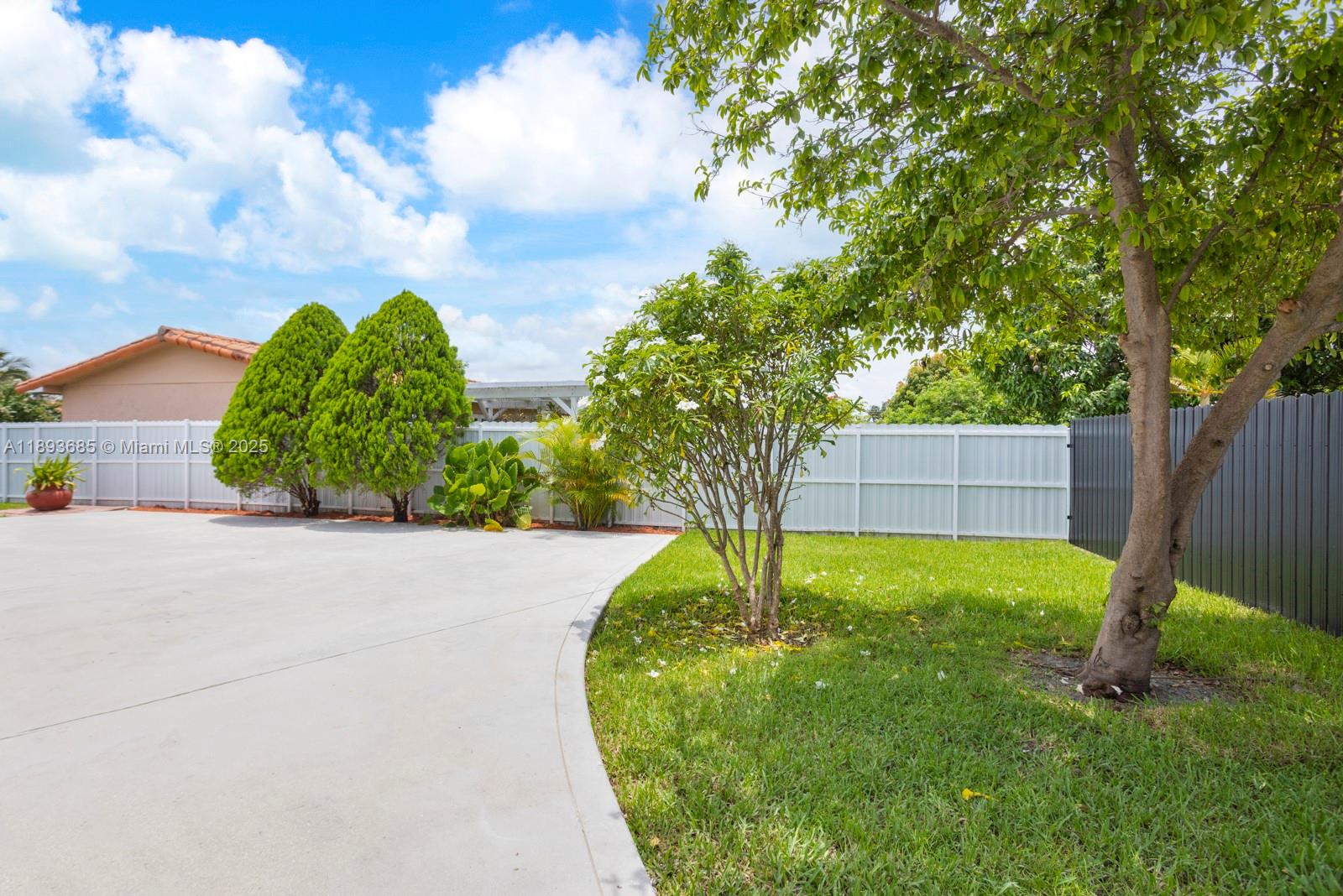 10770 Southwest 26th Street Miami, FL 33165 - Photo 32 of 35 a backyard of a house with lots of green space