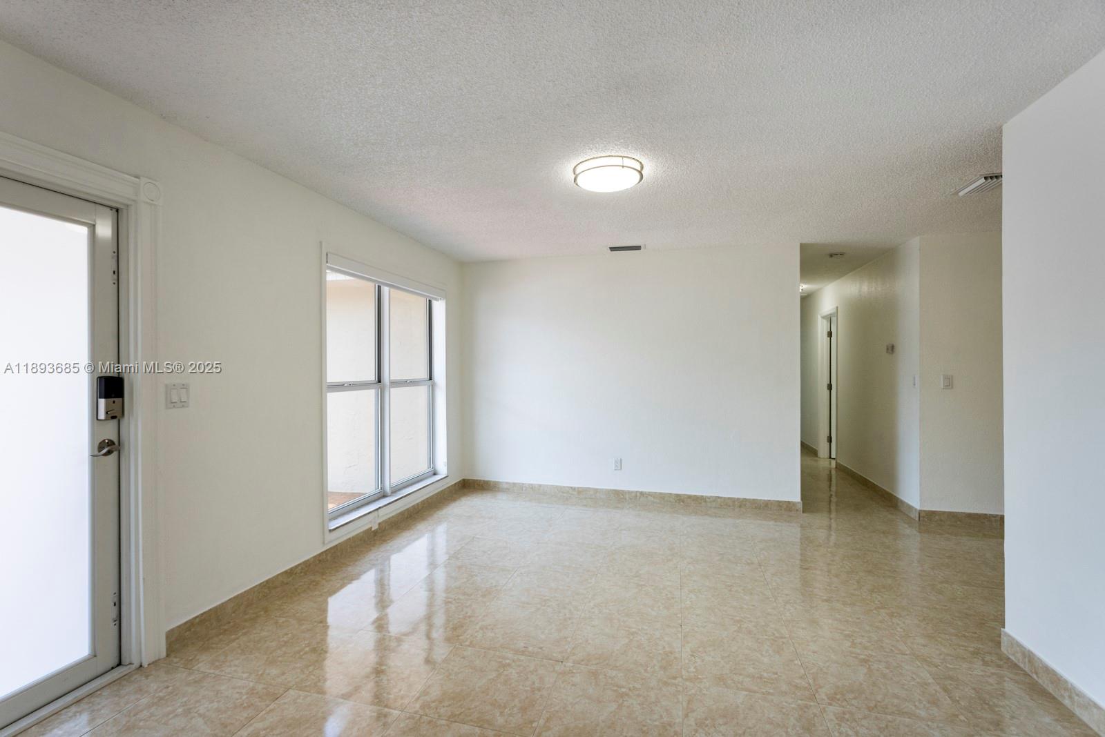 10770 Southwest 26th Street Miami, FL 33165 - Photo 6 of 35 an empty room with windows and closet