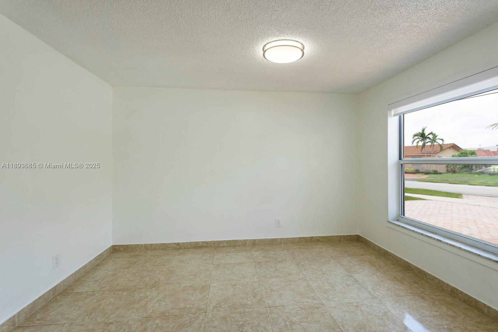 10770 Southwest 26th Street Miami, FL 33165 - Photo 8 of 35 a view of an empty room and window