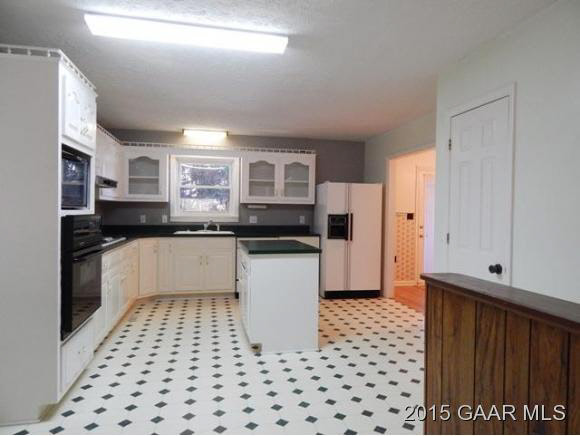660 Ladd Road Fishersville, VA 22939 - Photo 15 of 40 a kitchen with a sink a stove cabinets and a refrigerator