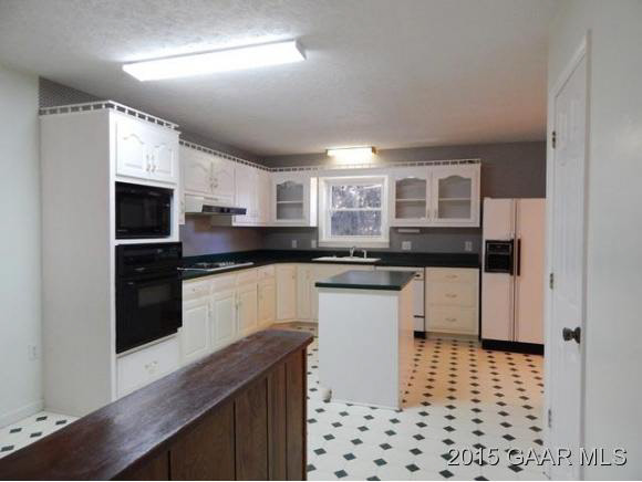 660 Ladd Road Fishersville, VA 22939 - Photo 16 of 40 a kitchen with stainless steel appliances kitchen island granite countertop a sink and cabinets
