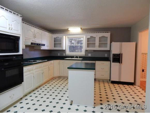 660 Ladd Road Fishersville, VA 22939 - Photo 17 of 40 a kitchen with granite countertop a sink a stove a refrigerator and cabinets