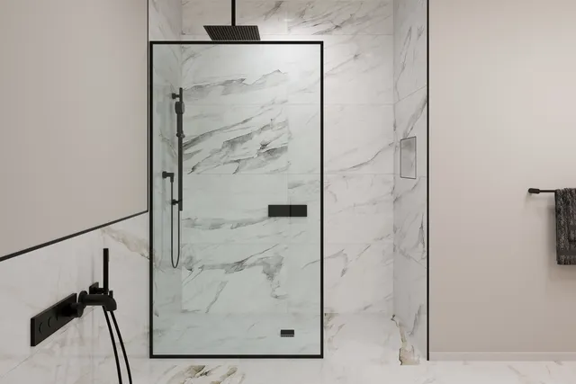 a bathroom with a glass shower door