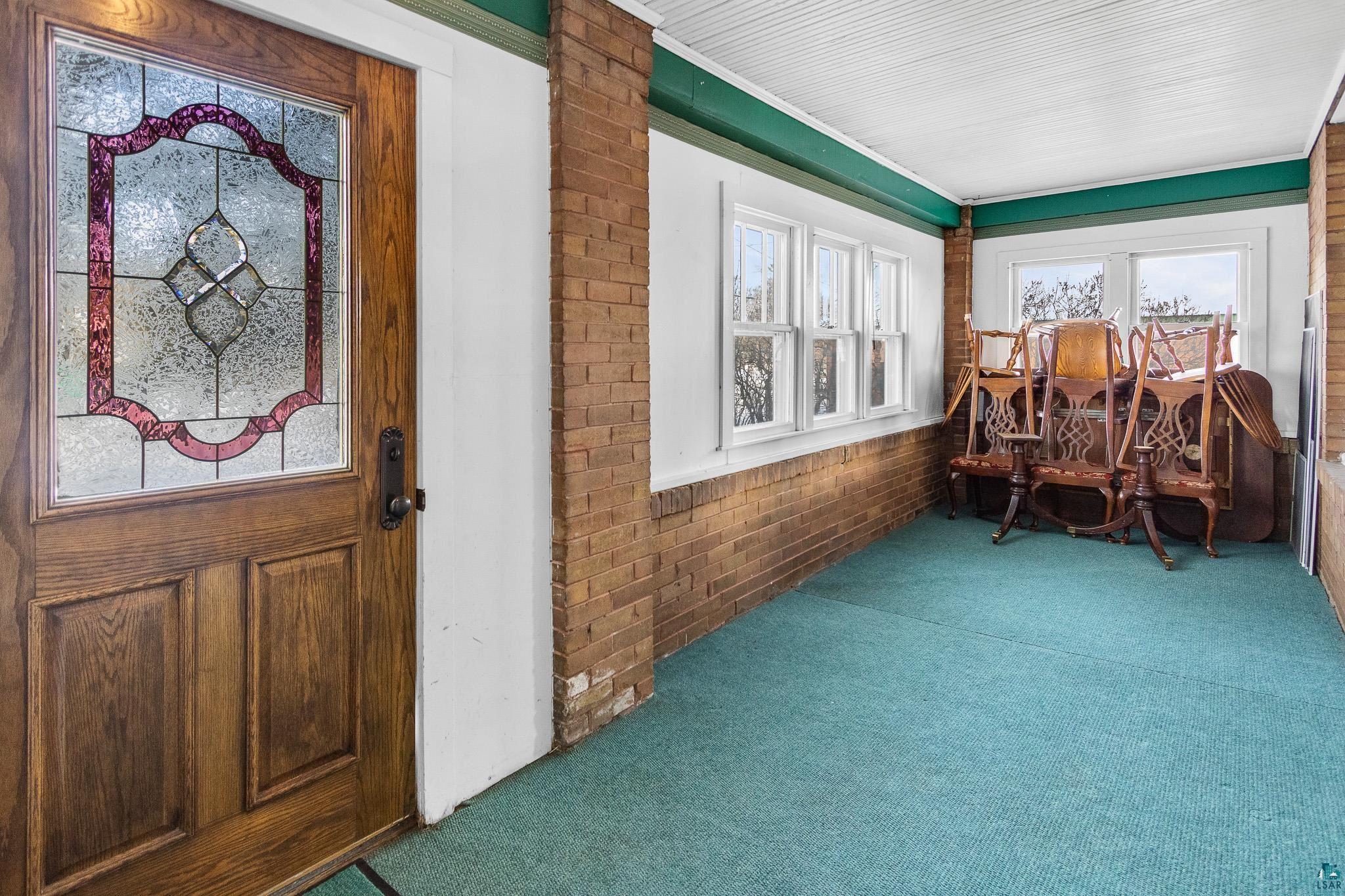6494 School Street Finlayson, MN 55735 - Photo 21 of 31 Sunroom / solarium featuring carpet flooring, brick wall, and healthy amount of natural light