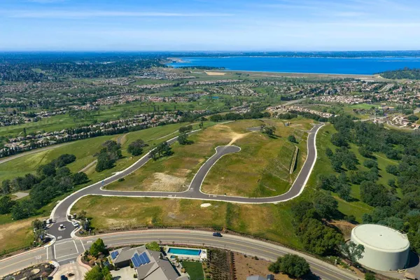 an aerial view of a residential houses with outdoor space and a swimming pool