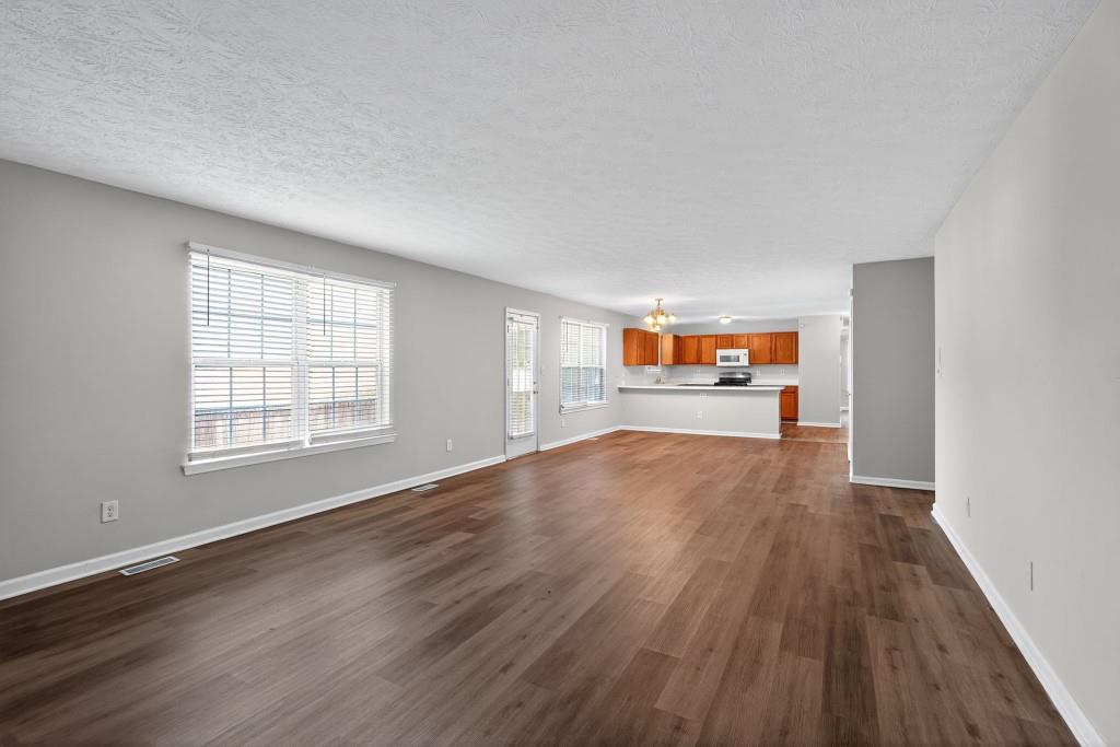 3737 Waldrop Road Decatur, GA 30034 - Photo 11 of 23 an empty room with wooden floor and windows