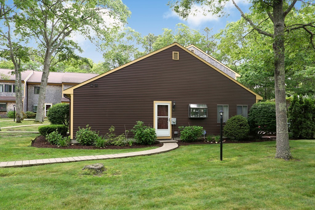 20 Round House Road, Unit 20 Bourne, MA 02532 - Photo 1 of 22 a house view with a garden space