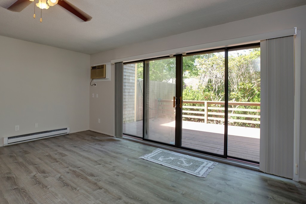 20 Round House Road, Unit 20 Bourne, MA 02532 - Photo 18 of 22 an empty room with wooden floor and windows