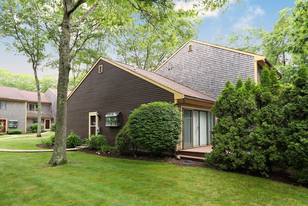 20 Round House Road, Unit 20 Bourne, MA 02532 - Photo 2 of 22 a view of a house with a yard plants and large tree