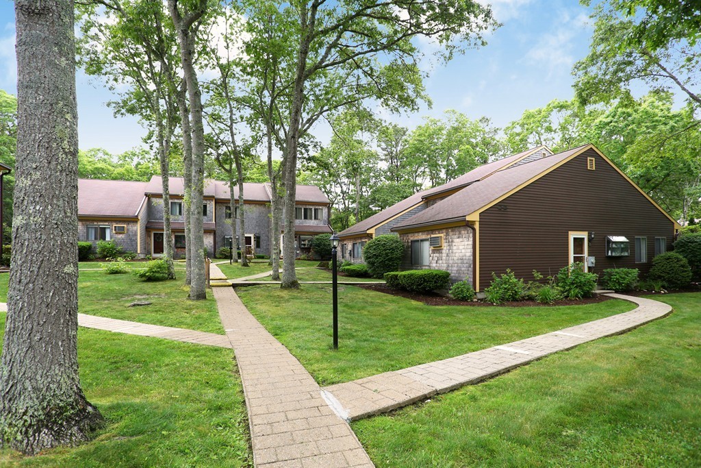 20 Round House Road, Unit 20 Bourne, MA 02532 - Photo 3 of 22 a view of a house that has a yard