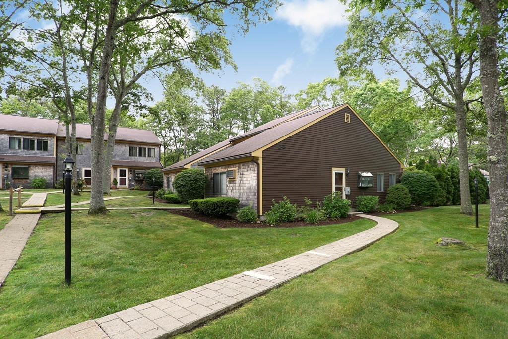20 Round House Road, Unit 20 Bourne, MA 02532 - Photo 4 of 22 a front view of a house with a yard