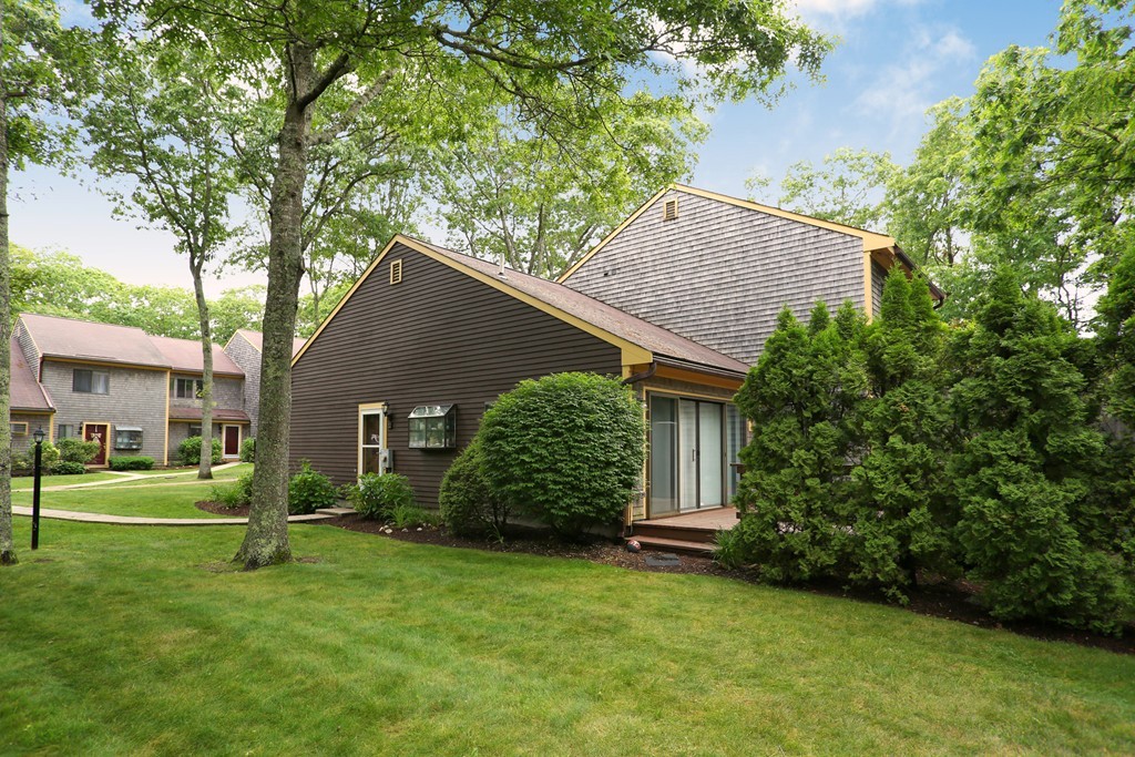 20 Round House Road, Unit 20 Bourne, MA 02532 - Photo 7 of 22 a backyard of a house with plants and large tree