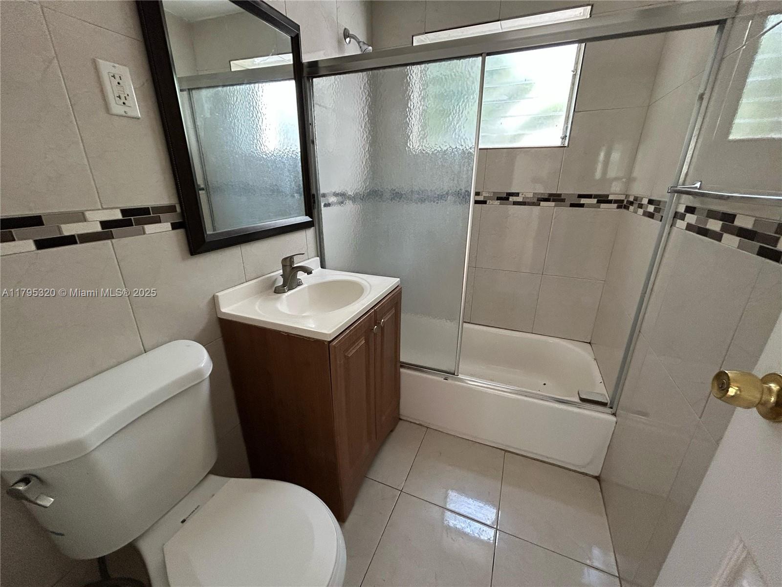 8321 Crespi Boulevard, Unit 1 Miami Beach, FL 33141 - Photo 5 of 15 a bathroom with a sink toilet and shower