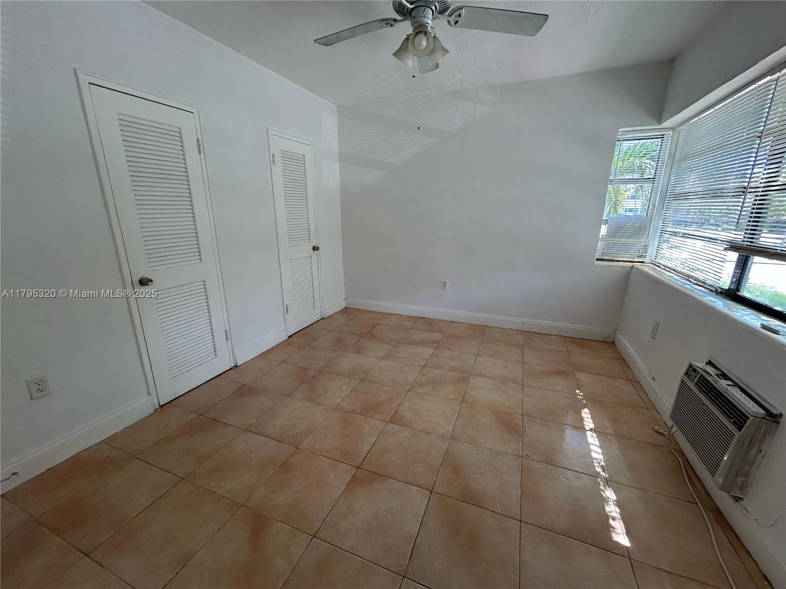 8321 Crespi Boulevard, Unit 1 Miami Beach, FL 33141 - Photo 6 of 15 a view of an empty room with a window