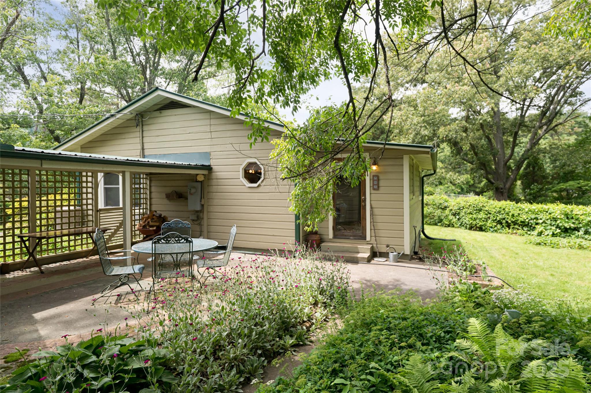 75 Cisco Road Asheville, NC 28805 - Photo 11 of 47 a view of backyard with a table and chairs and potted plants