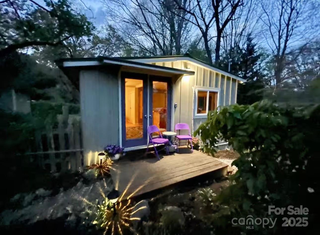 75 Cisco Road Asheville, NC 28805 - Photo 2 of 47 a backyard of a house with fountain plants and trees