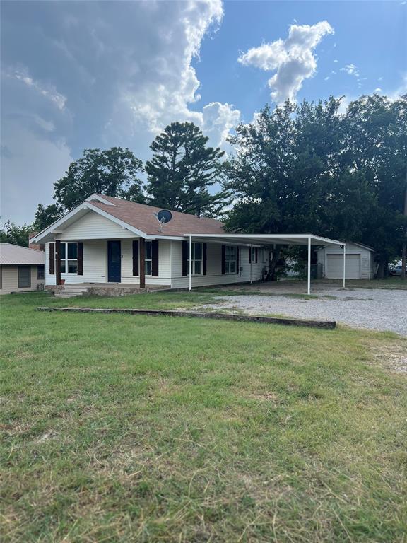 202 South 7th Street Jacksboro, TX 76458 - Photo 2 of 12 a house view with a garden space