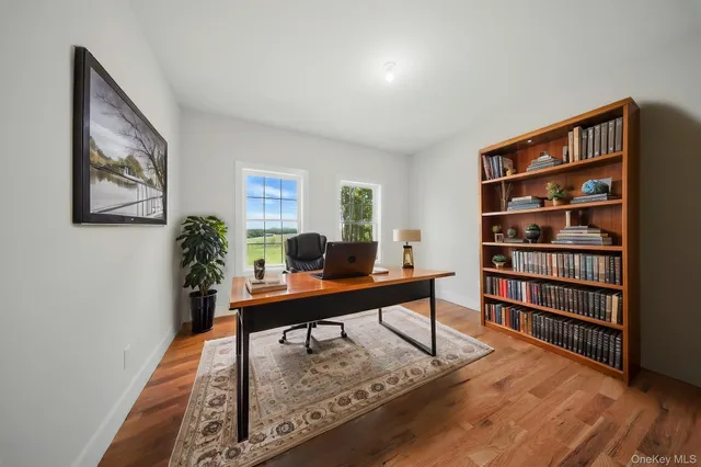 a bathroom with a granite countertop sink a mirror and a shower