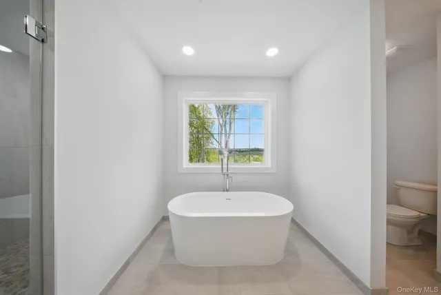 a spacious bathroom with a double vanity sink tub and mirror