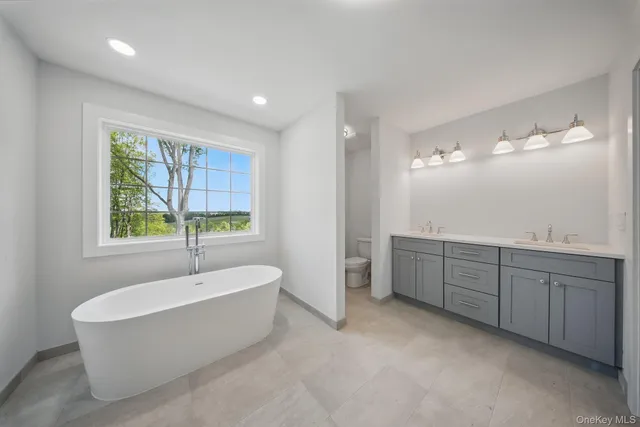 a bathroom with a toilet a sink and a shower