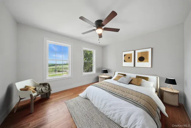 a bedroom with a bed chandelier and a window