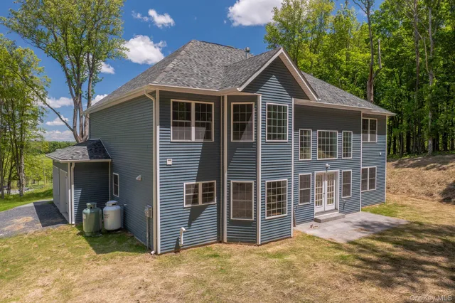 a view of a house with pool and a yard