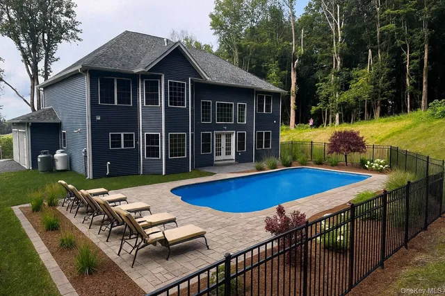 an aerial view of residential house with trees all around