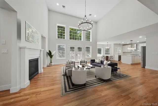 a kitchen with a dining table chairs wooden floor appliances and cabinets