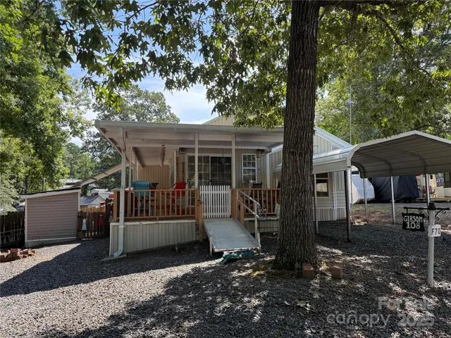 a view of a house with a yard and sitting area