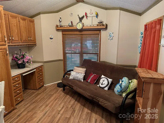 a view of a living room with furniture and wooden floor