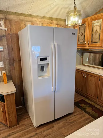 a kitchen with stainless steel appliances a refrigerator and a stove top oven