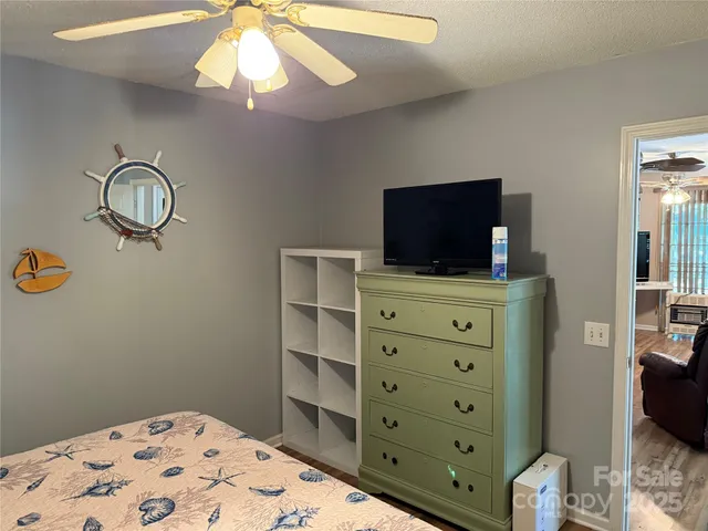 a view of a bedroom with baby bed and closet