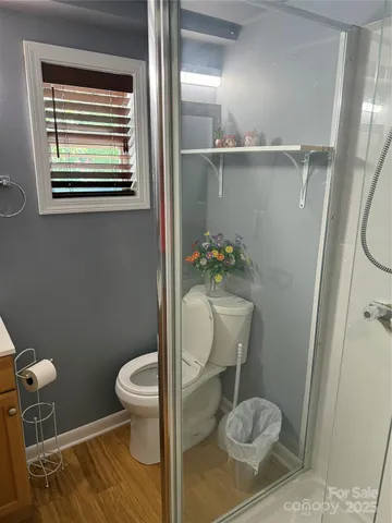 a bathroom with a toilet and a shower