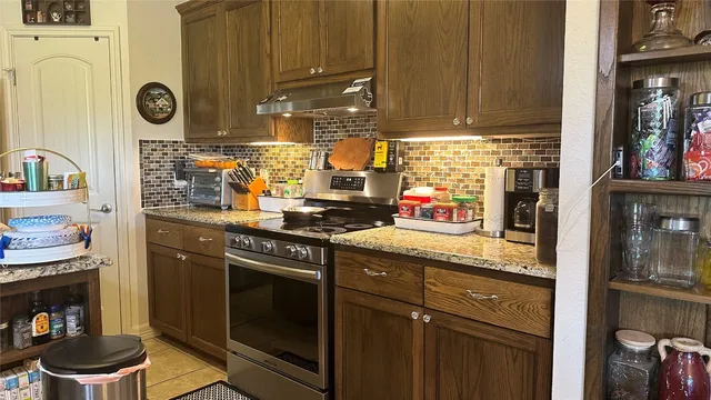 a kitchen with a sink cabinets and appliances