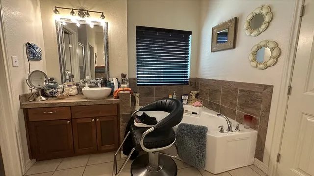 a bathroom with a tub sink and mirror