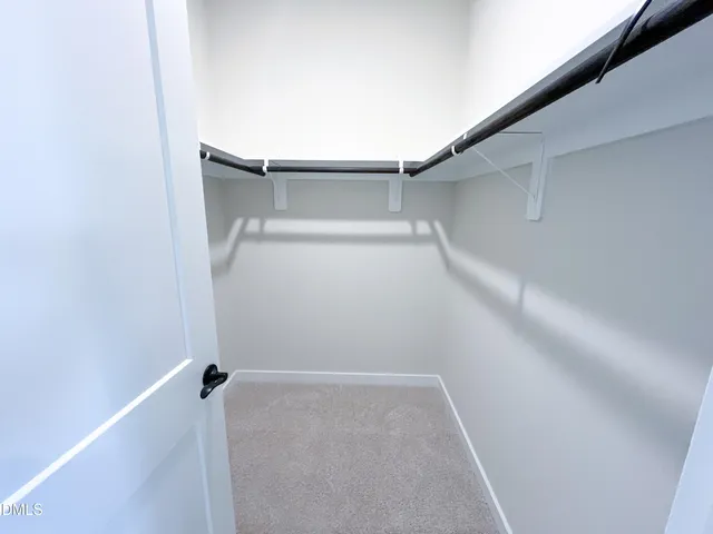 a view of a patio with a table chairs and a floor to ceiling window